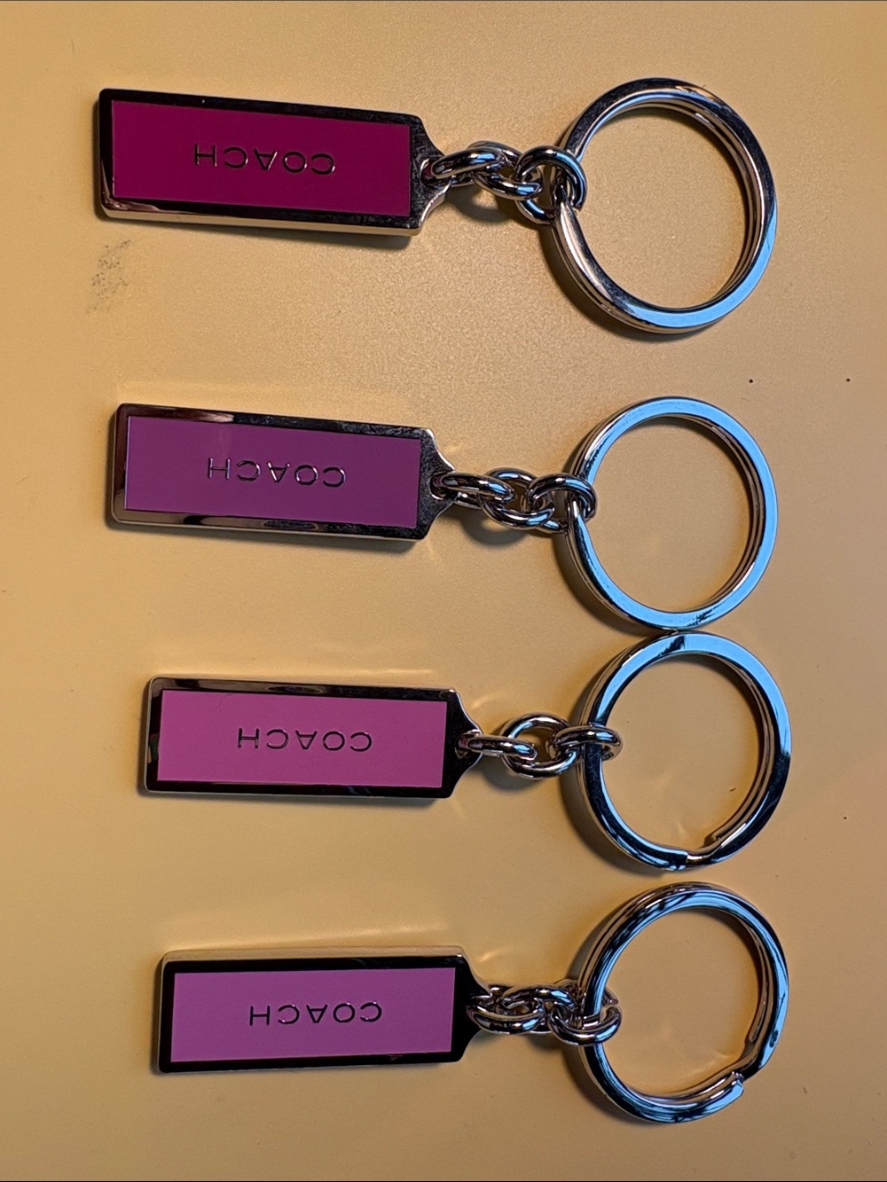 Coach Set of 4 Pink and Silver Logo Key Tag Keychain